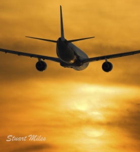 Airplane Flying into Sunnset