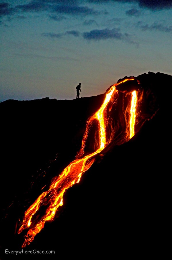 Guy walking near a lava flow